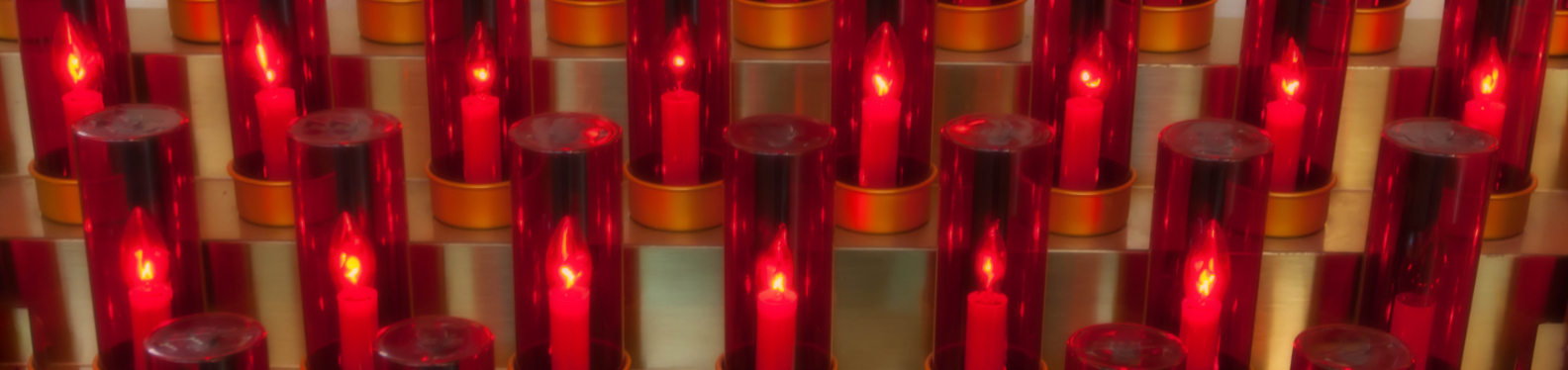 Red Votive candles in 2 rows all lit
